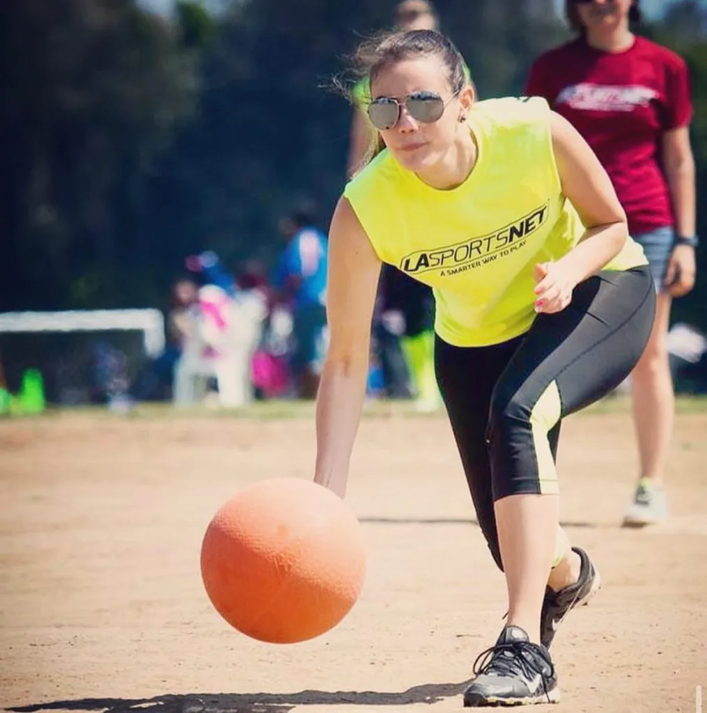 A girl throws a kickball during a league game in Los Angeles, CA.