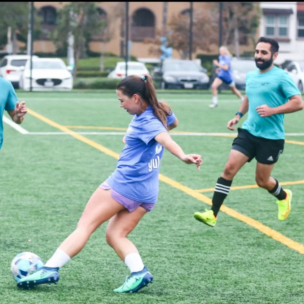 A girl kicking a soccer ball while playing on a recreational soccer team in Los Angeles.