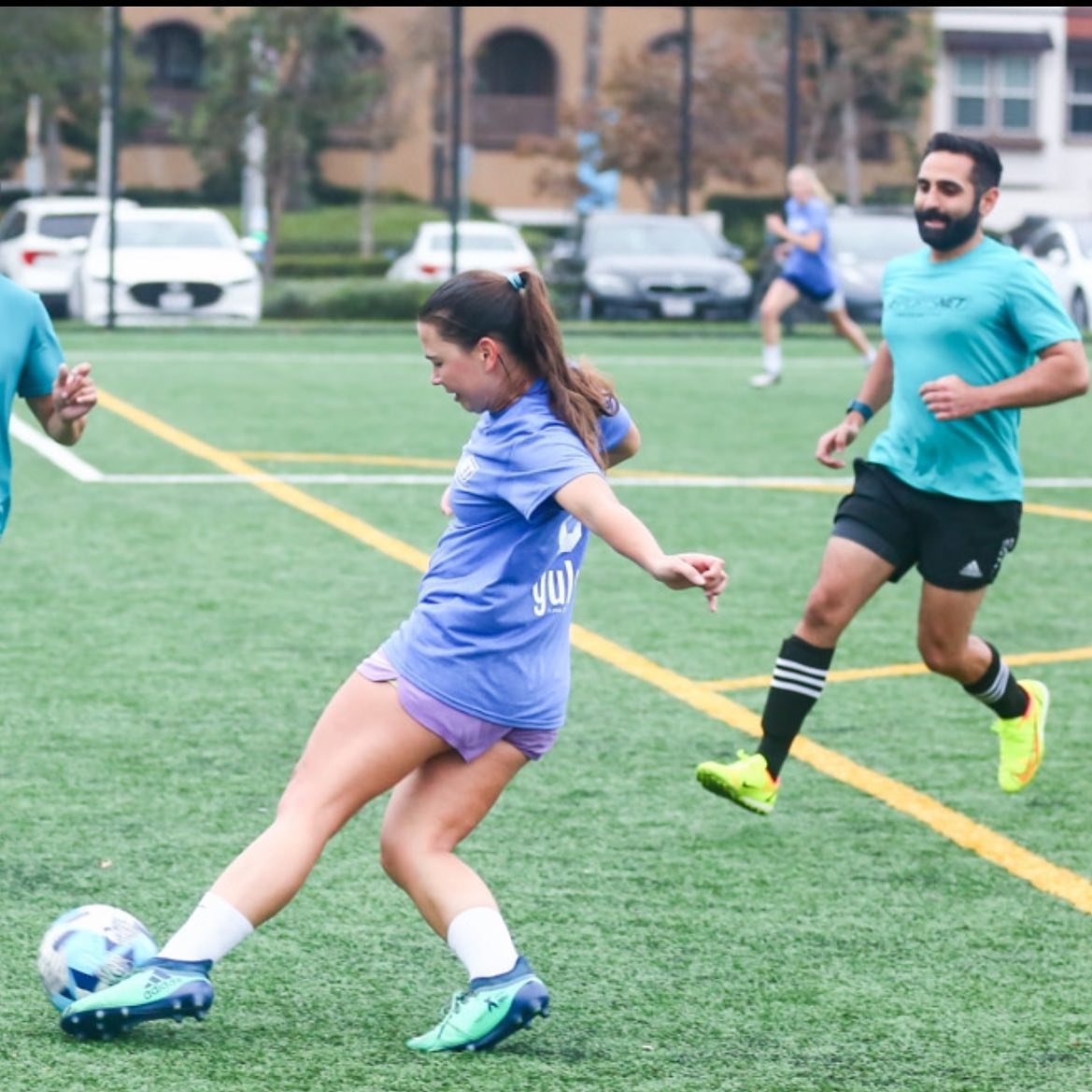 A girl plays soccer at an adult soccer league in Hollywood, CA.