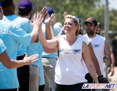 adult softball players staying hydrated during a summer league game in Los Angeles