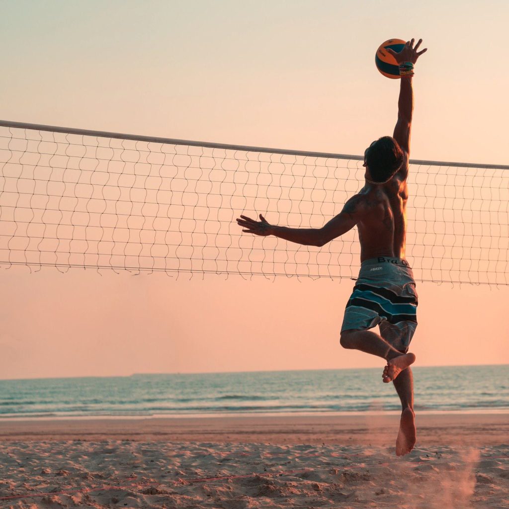 A man reaches for a volleyball during a beach game in Los Angeles.