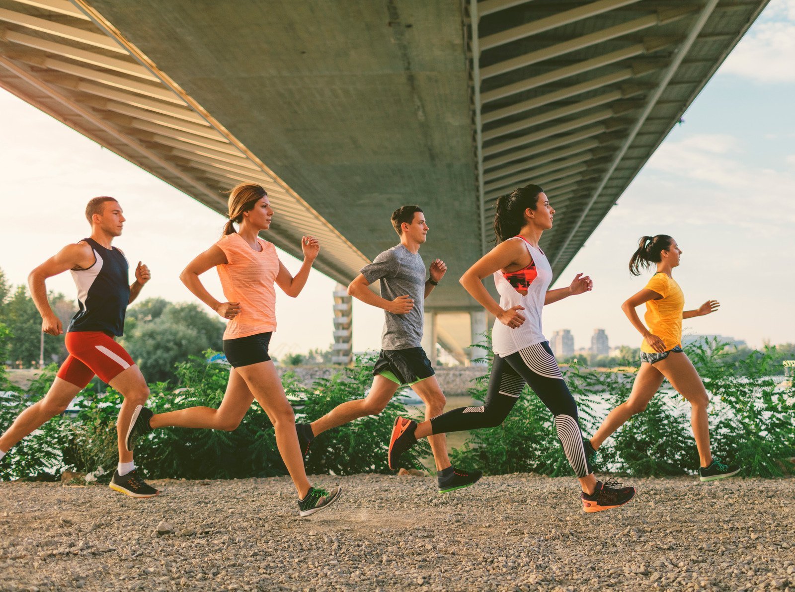 a group of young adults running - what should you bring to your first adult sports league game?