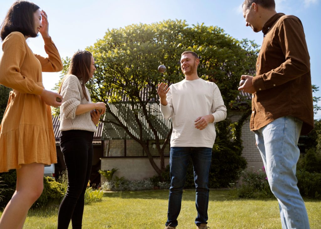a diverse group of young adults standing in a group and speaking happily to each other, making new friends in Los Angeles when seeking to find things to do alone in Los Angeles