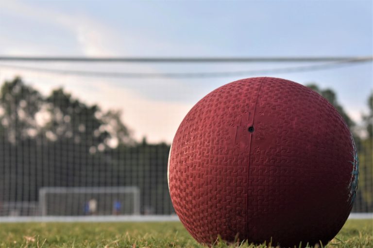 A red kickball on the grass field at a park near Los Angeles before LASportsNet adult kickball game